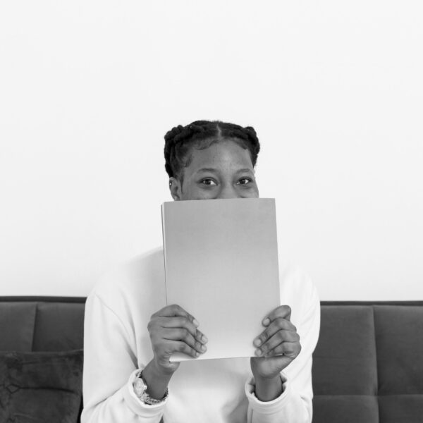 woman-covering-face-with-book bw